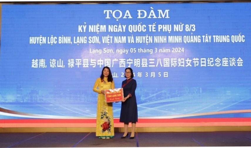 禄平县代表团代表（左）向广西壮族自治区宁明县代表团赠送礼物。