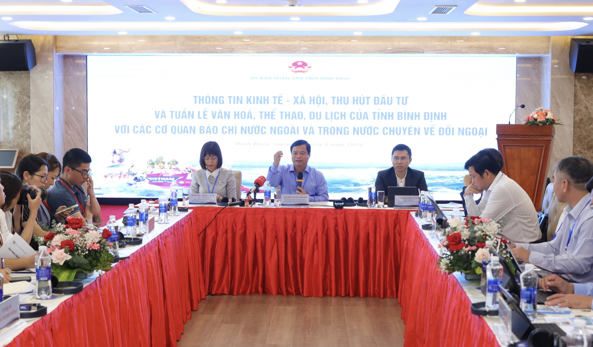 平定省人民委员会常务副主席阮俊青先生（身穿蓝色衬衫，中）与媒体就该省的经济、社会和旅游信息交换意见。