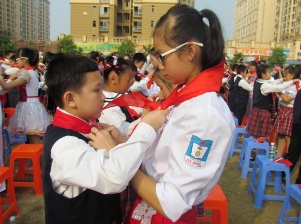 越中边境青少年友谊交流活动中，越中队员互相佩戴红领巾。