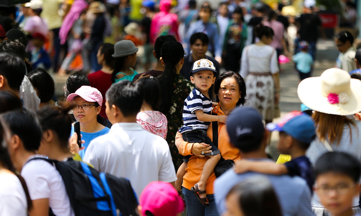 人们带着孩子参观胡志明市动植物园的游乐园 。